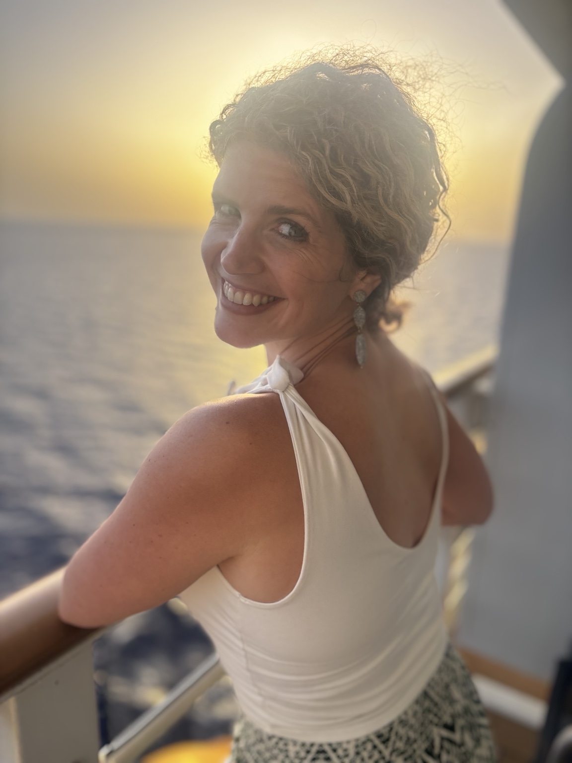 Rachel Armas smiling at sunset on a cruise